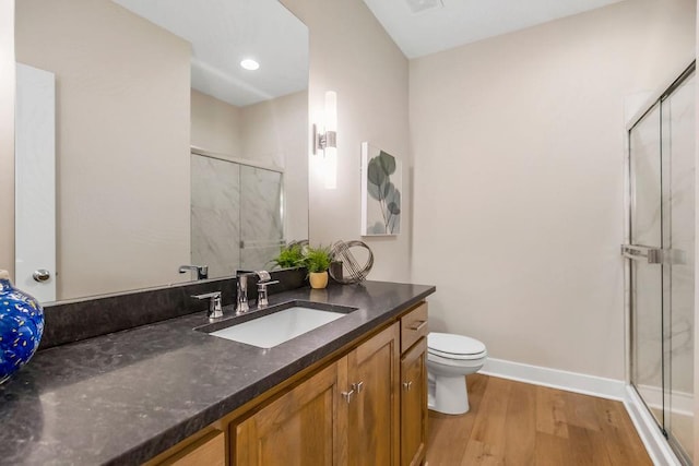 bathroom with vanity, wood-type flooring, walk in shower, and toilet