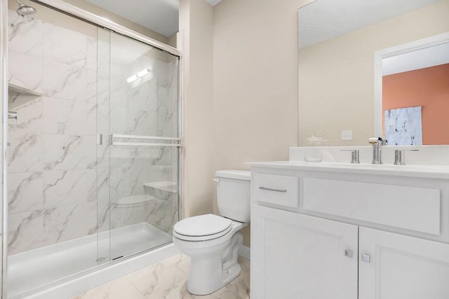 bathroom with vanity, a shower with door, and toilet