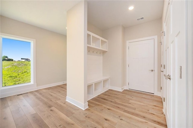 mudroom with light hardwood / wood-style floors