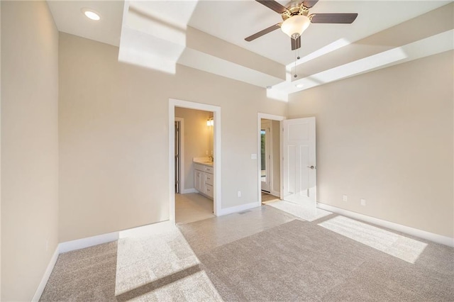 empty room featuring ceiling fan and light carpet