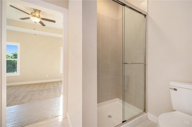 bathroom with an enclosed shower, ceiling fan, and toilet