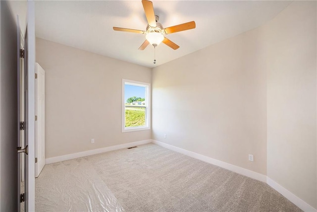 carpeted spare room with ceiling fan