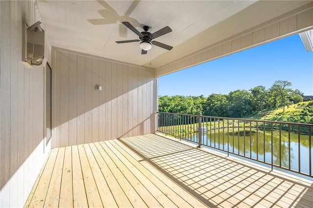 deck with a water view and ceiling fan