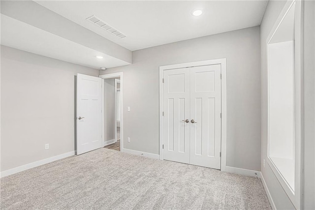 unfurnished bedroom with a closet and carpet