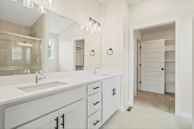 bathroom featuring vanity, tile patterned floors, and an enclosed shower