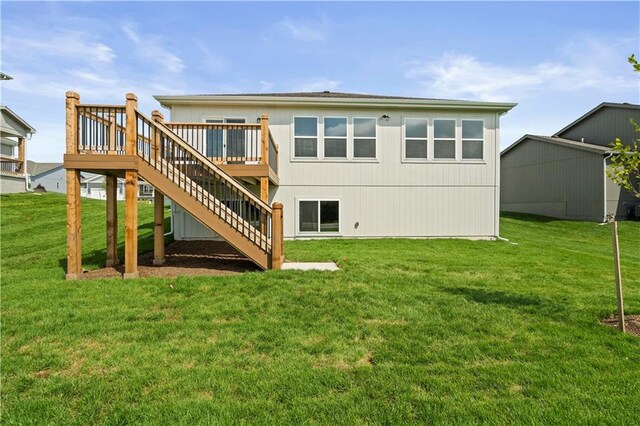 rear view of house with a yard and a wooden deck