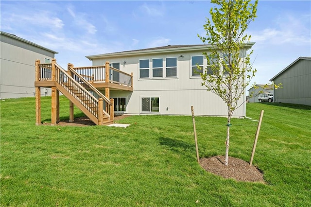 rear view of property featuring a wooden deck and a yard