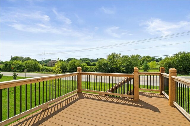 wooden terrace with a lawn