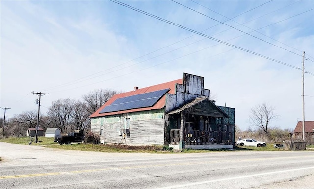 view of property exterior with solar panels