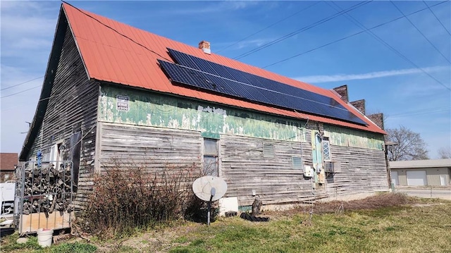 view of home's exterior with solar panels