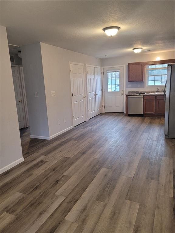 kitchen with dark hardwood / wood-style flooring and stainless steel appliances