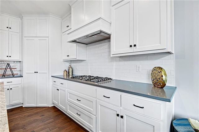 kitchen with white cabinets, custom range hood, dark hardwood / wood-style floors, and stainless steel gas cooktop