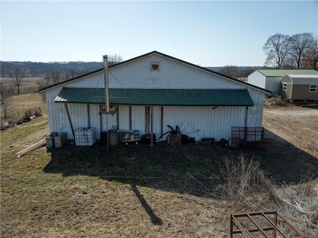 view of outdoor structure featuring a lawn