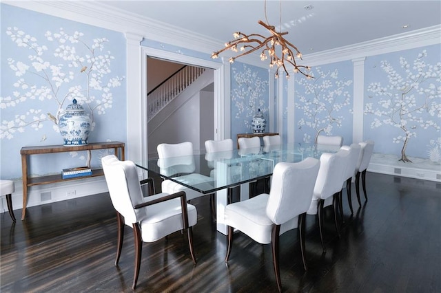 dining area with ornamental molding, dark hardwood / wood-style flooring, a chandelier, and ornate columns