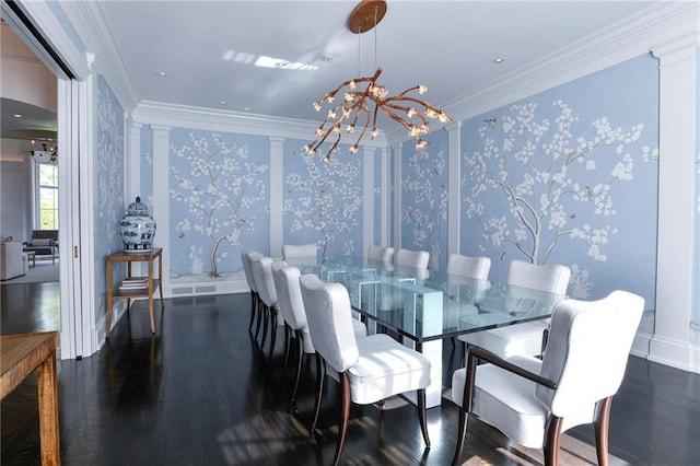 dining room featuring ornate columns, dark hardwood / wood-style floors, an inviting chandelier, and ornamental molding