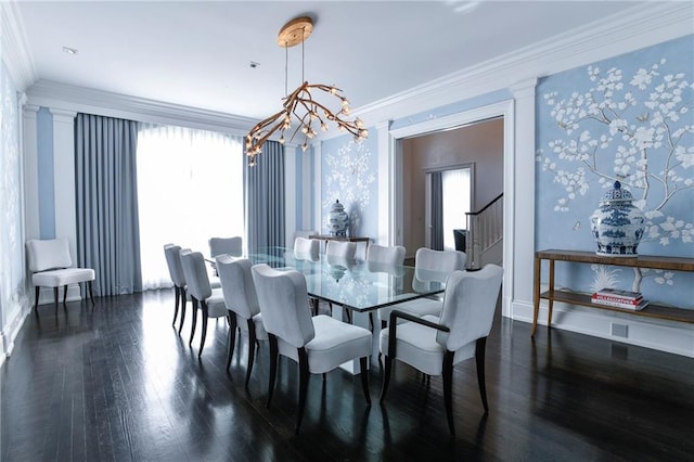 dining space with dark wood-type flooring, ornamental molding, and a chandelier