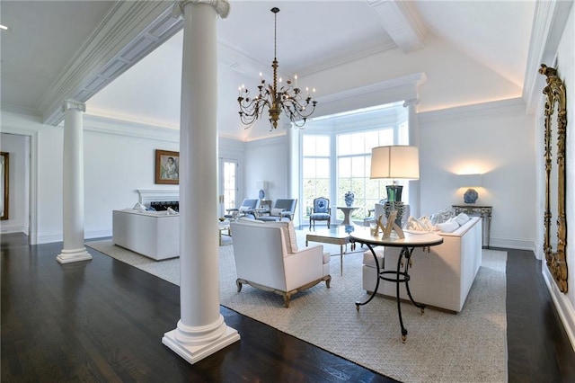 living room featuring decorative columns, an inviting chandelier, dark hardwood / wood-style flooring, and ornamental molding