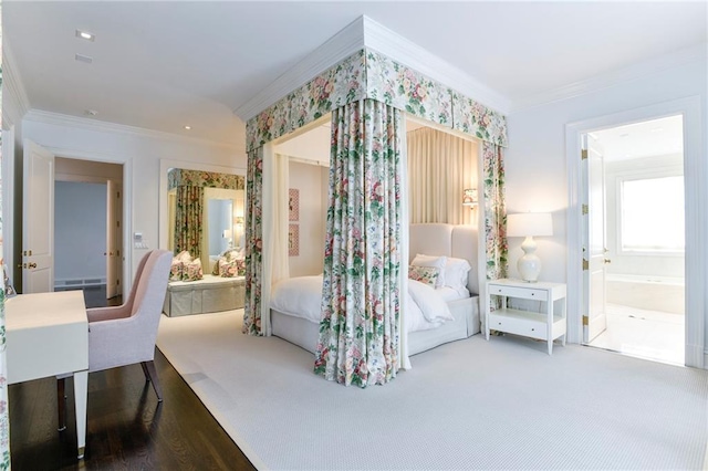 bedroom with crown molding, wood-type flooring, and ensuite bath