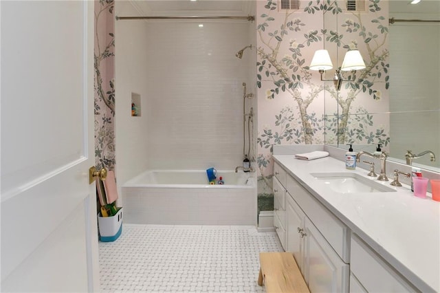 bathroom with tiled shower / bath combo, vanity, and tile patterned flooring