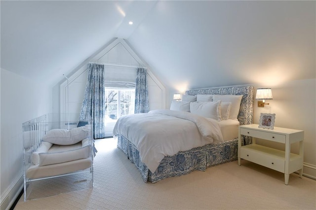 bedroom featuring lofted ceiling and light colored carpet