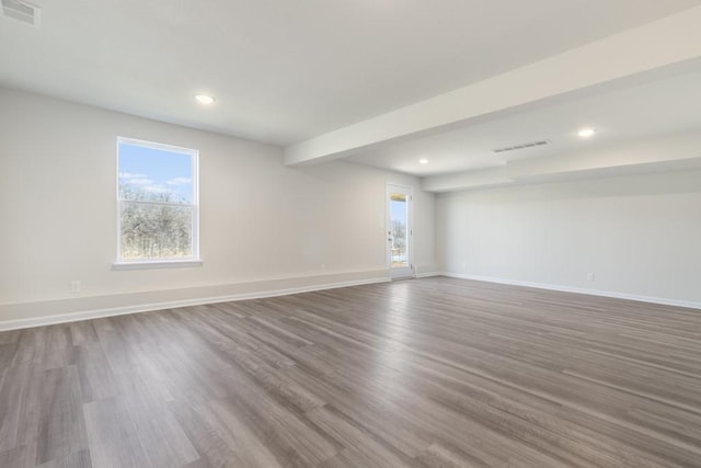 unfurnished room featuring beam ceiling and hardwood / wood-style floors