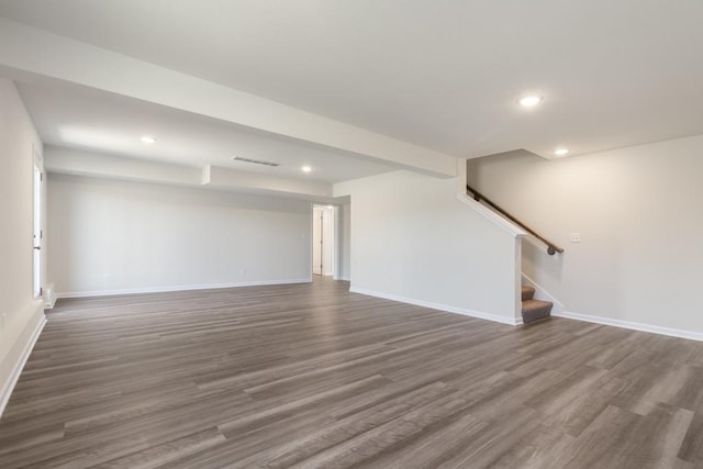 basement with dark hardwood / wood-style flooring