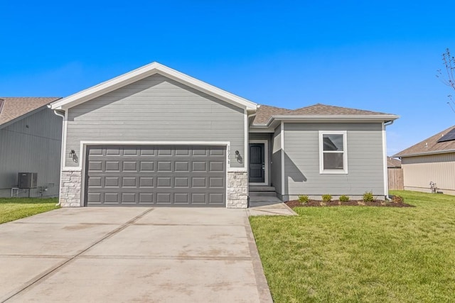 view of front of property featuring an attached garage, stone siding, a front lawn, and central AC