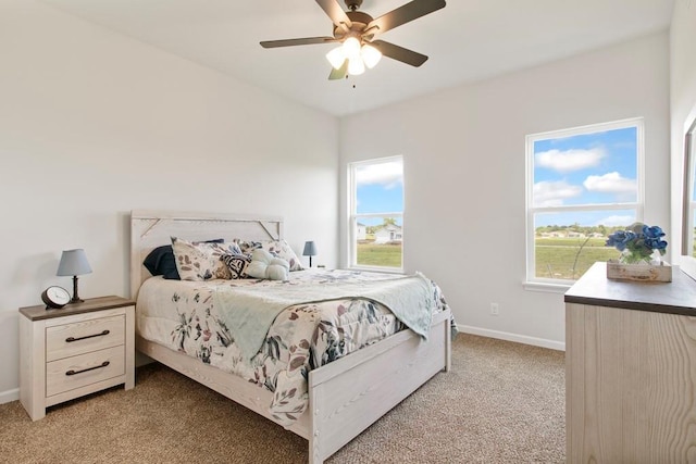 10298 Lucca Ln, Peculiar, MO 64078 - bedroom featuring light colored carpet, multiple windows, baseboards, and a ceiling fan