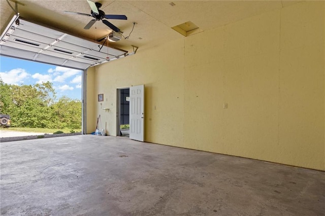 garage with a garage door opener and ceiling fan