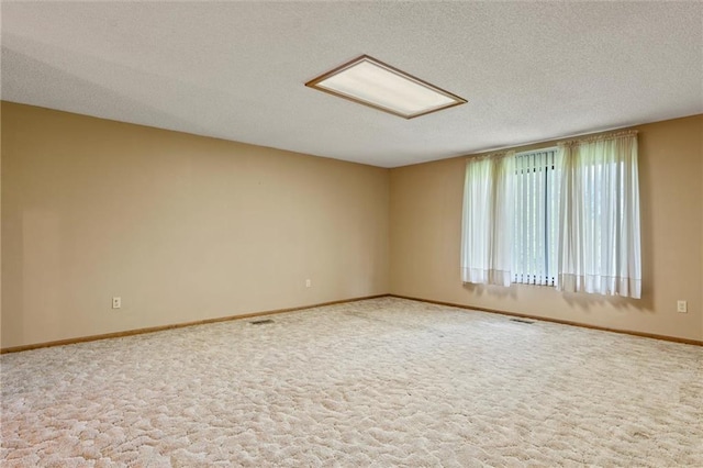 empty room featuring carpet floors and a textured ceiling