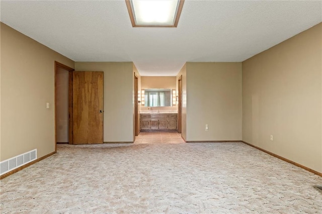 empty room featuring light carpet