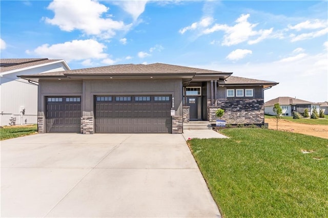 prairie-style house featuring a front yard and a garage