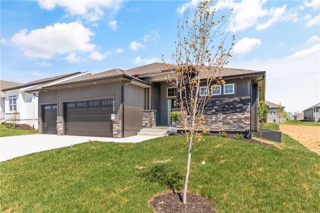 view of front of home with a front yard and a garage