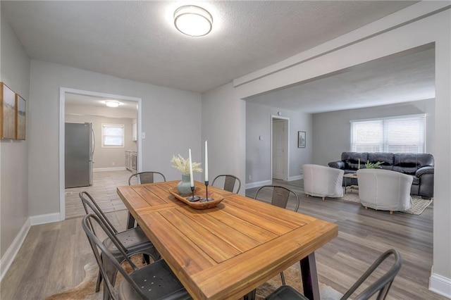 dining space with light wood-type flooring