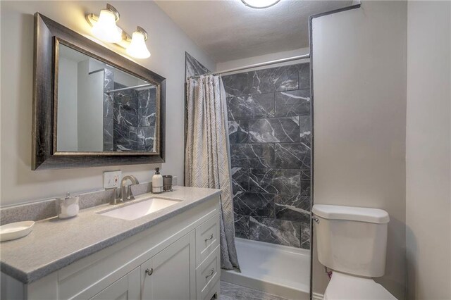 bathroom with toilet and vanity