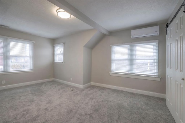 additional living space featuring an AC wall unit, a wealth of natural light, and light colored carpet