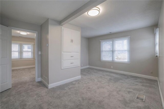 unfurnished room with light carpet