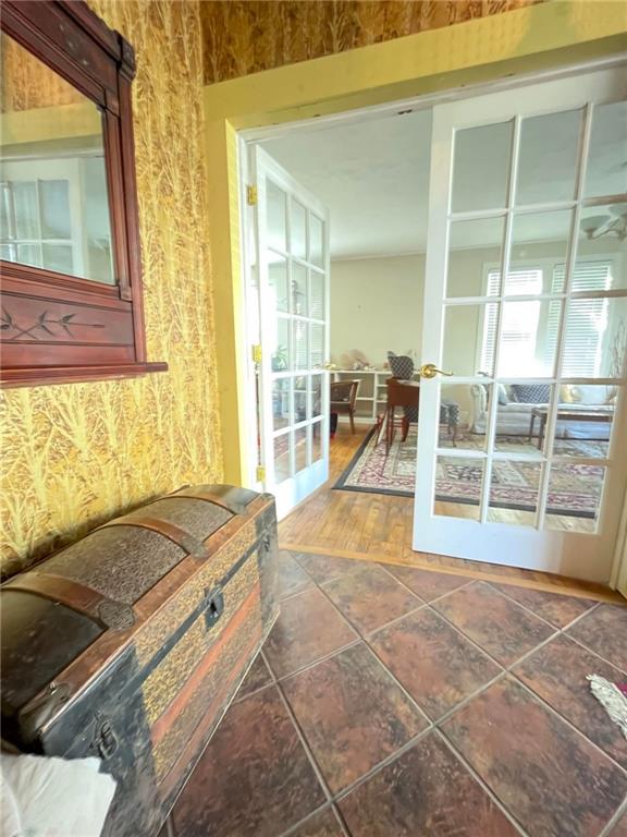 interior space with ceiling fan and tile flooring