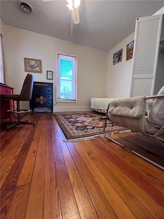 living room featuring dark hardwood / wood-style flooring and ceiling fan