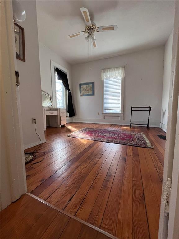 interior space featuring ceiling fan and dark hardwood / wood-style floors