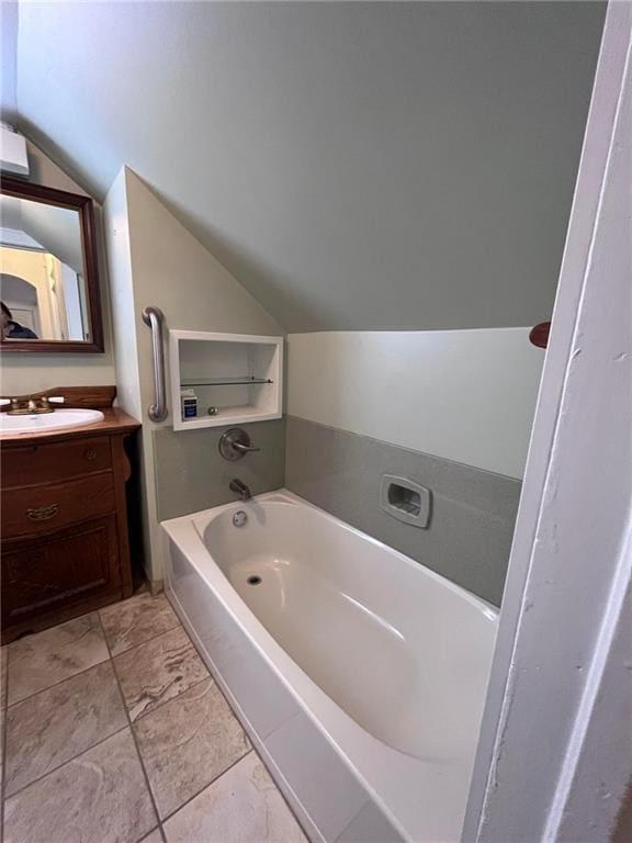 bathroom featuring vanity, lofted ceiling, and tile floors