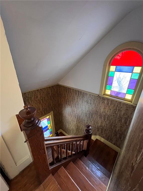 stairway featuring vaulted ceiling