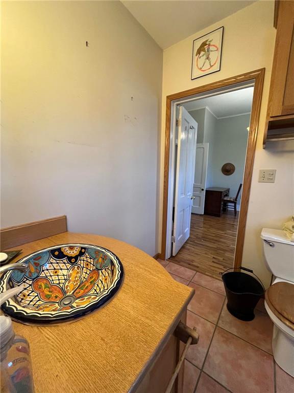 bathroom featuring toilet and tile flooring