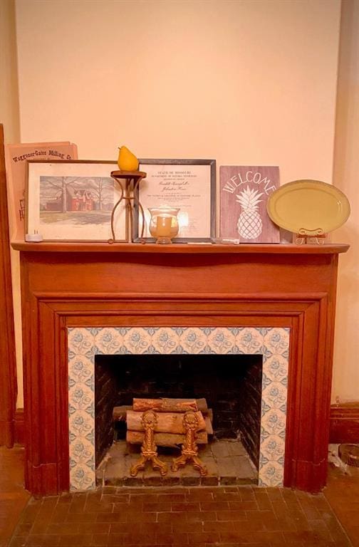 interior details featuring a tile fireplace