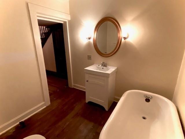 bathroom featuring a washtub, hardwood / wood-style floors, and oversized vanity