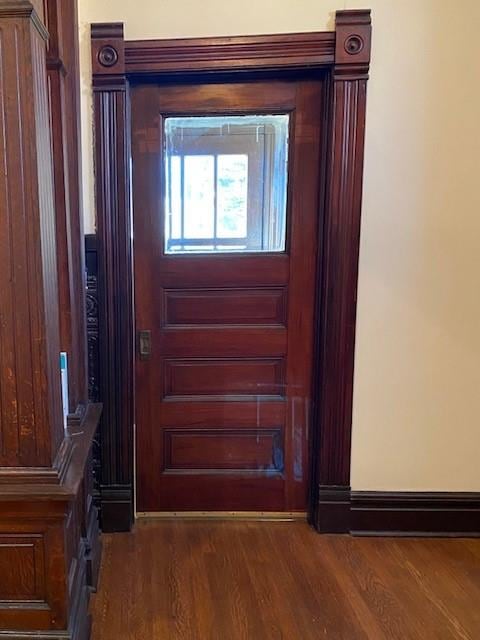 entryway with dark wood-type flooring