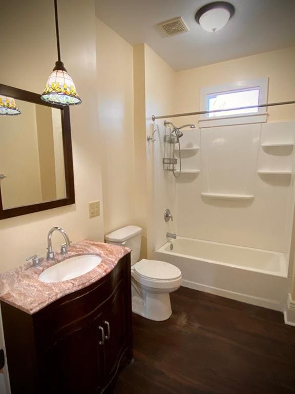 full bathroom featuring  shower combination, toilet, wood-type flooring, and vanity