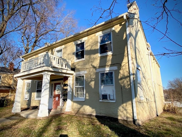 rear view of property featuring a balcony