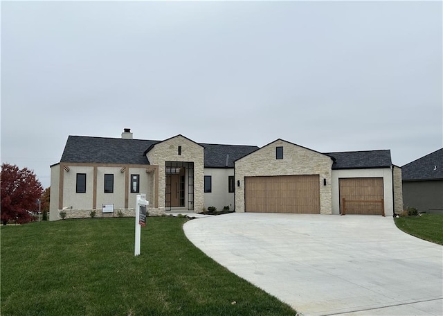 view of front of house featuring a front yard and a garage