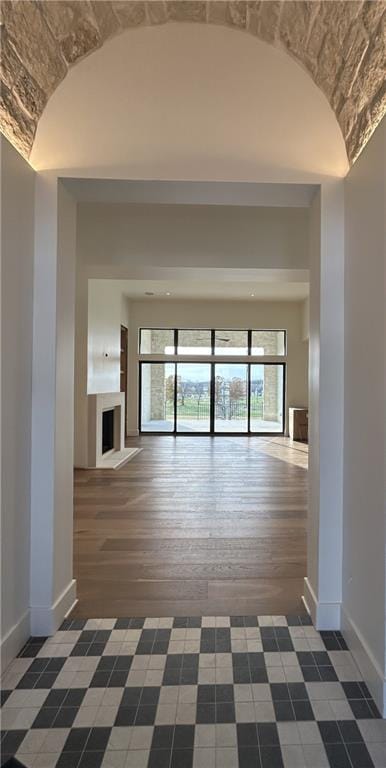 unfurnished living room with dark hardwood / wood-style flooring and vaulted ceiling